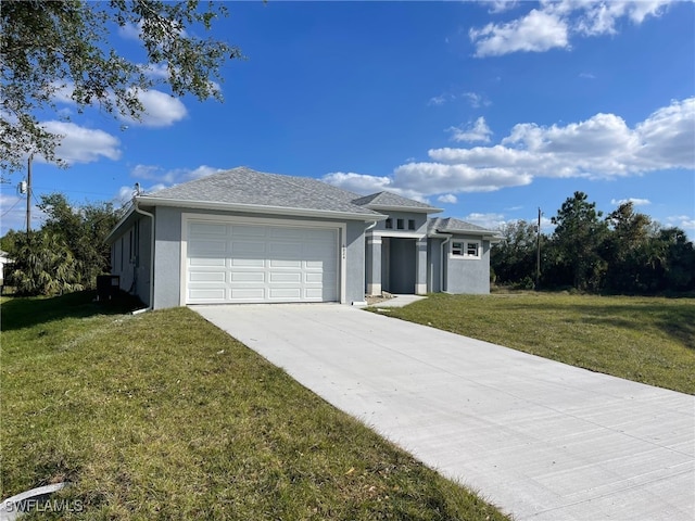 view of front of house with a front yard and a garage