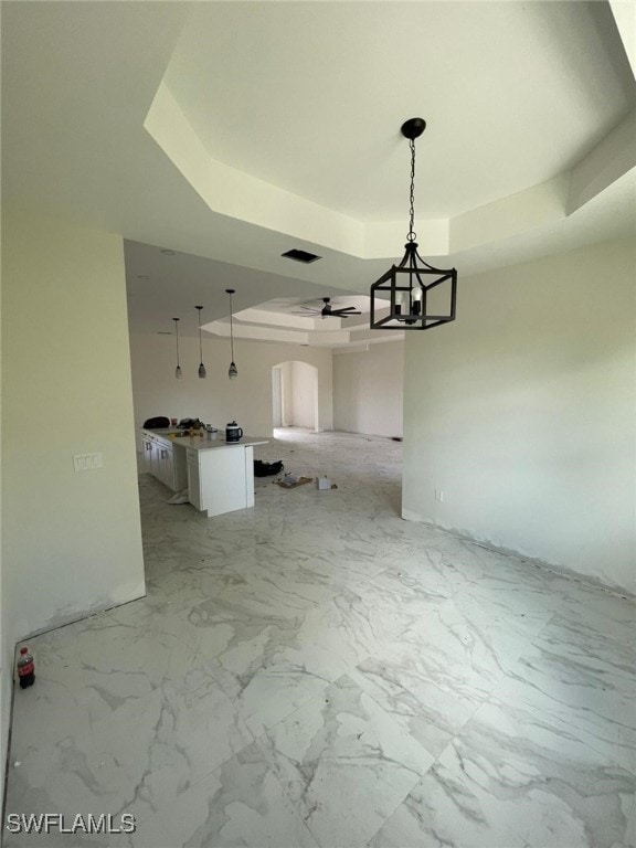 unfurnished room featuring a tray ceiling