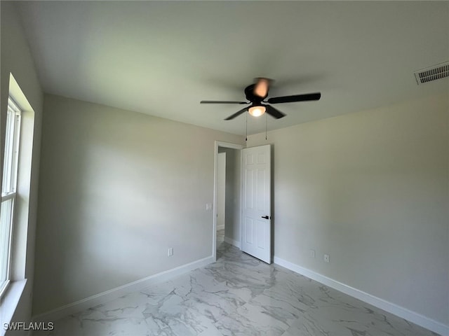 6024 Joplin Ave, Fort Myers, FL 33905 - spare room featuring baseboards, marble finish floor, ceiling fan, and visible vents