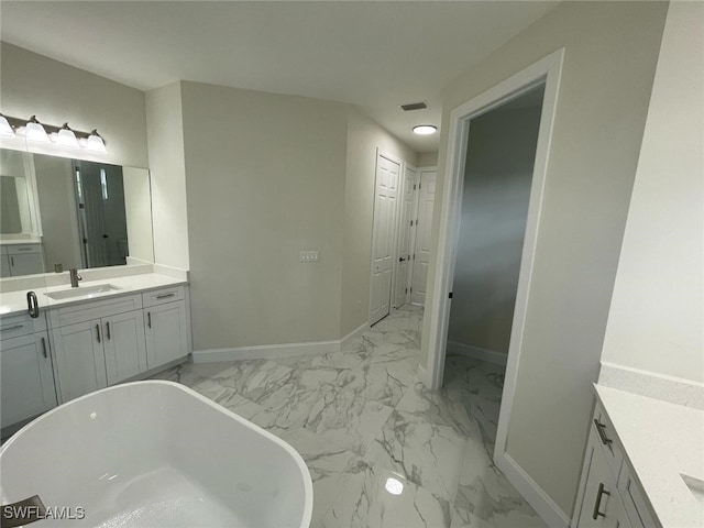 6024 Joplin Ave, Fort Myers, FL 33905 - full bath with marble finish floor, baseboards, visible vents, and a freestanding tub