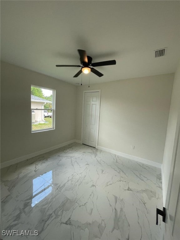 6024 Joplin Ave, Fort Myers, FL 33905 - unfurnished bedroom featuring a closet, visible vents, baseboards, marble finish floor, and a ceiling fan
