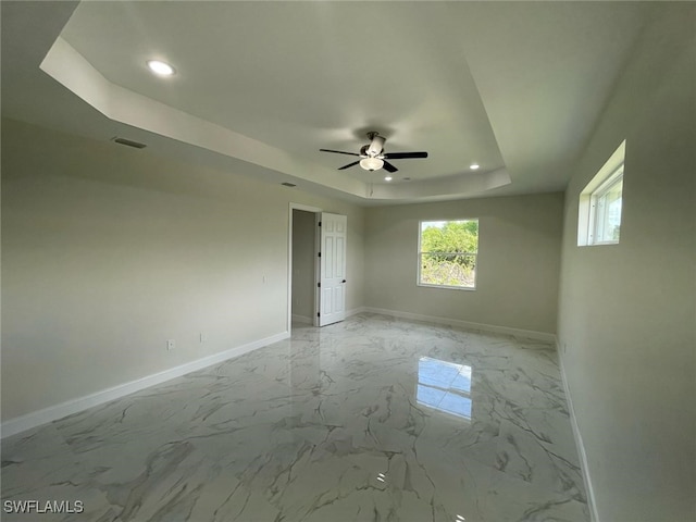 6024 Joplin Ave, Fort Myers, FL 33905 - unfurnished room featuring visible vents, baseboards, marble finish floor, ceiling fan, and a raised ceiling