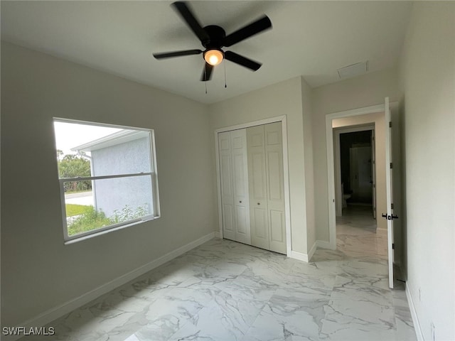 6024 Joplin Ave, Fort Myers, FL 33905 - unfurnished bedroom featuring baseboards, marble finish floor, ceiling fan, and a closet