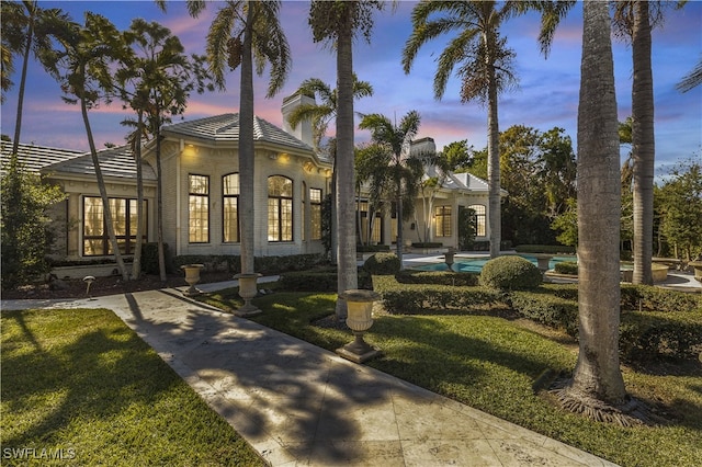 view of front of home with a yard