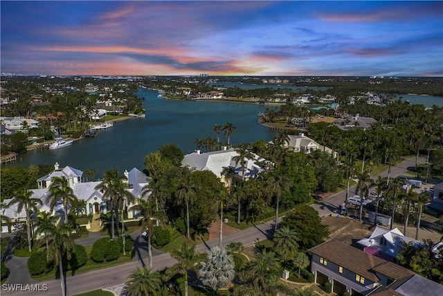 aerial view at dusk with a water view