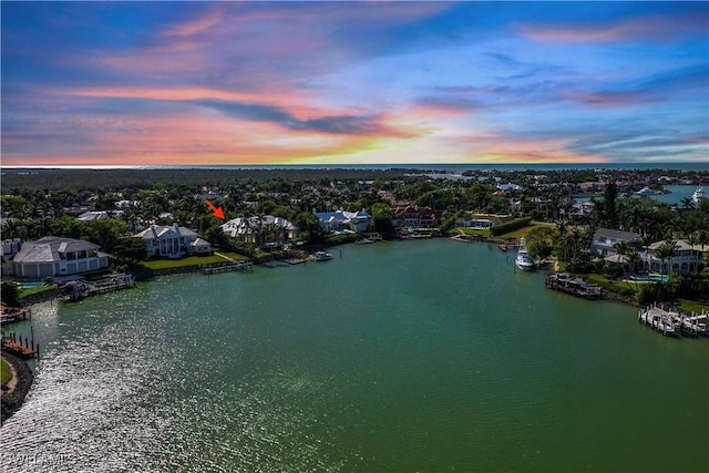 aerial view at dusk with a water view