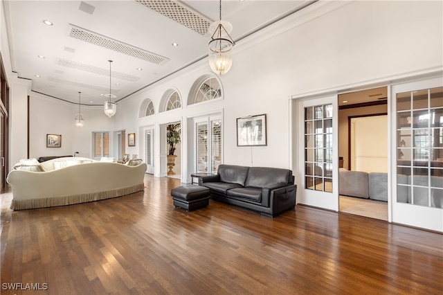 bedroom with a high ceiling, french doors, and hardwood / wood-style floors