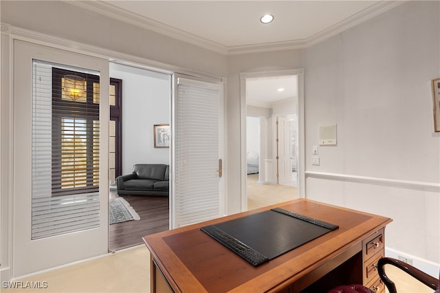 office with light hardwood / wood-style floors and ornamental molding