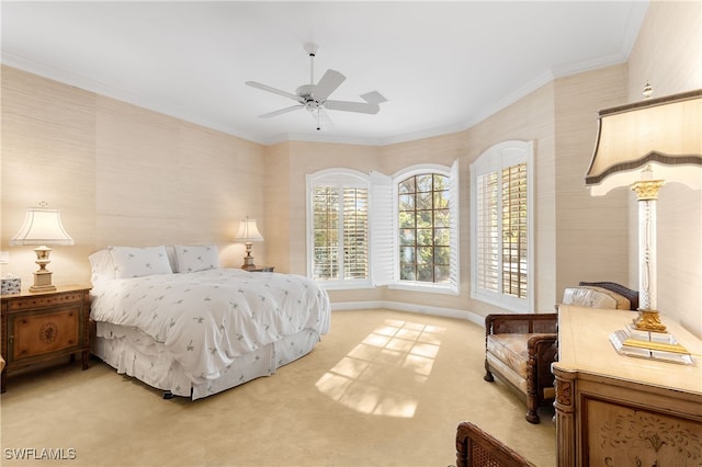 carpeted bedroom featuring ceiling fan and ornamental molding