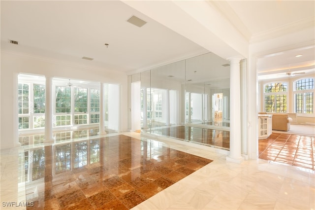 interior space featuring decorative columns and ornamental molding