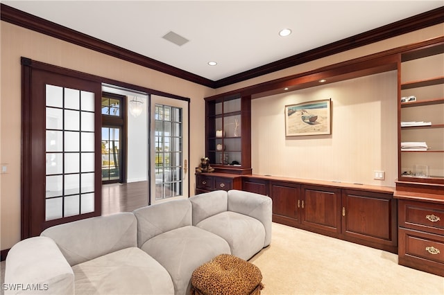 carpeted living room with crown molding and french doors