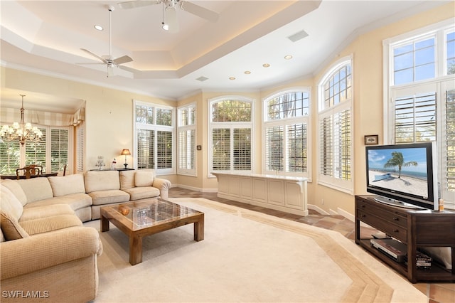 living room featuring ceiling fan with notable chandelier, plenty of natural light, and ornamental molding