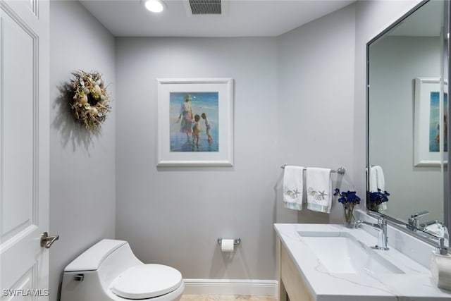 bathroom featuring vanity and toilet