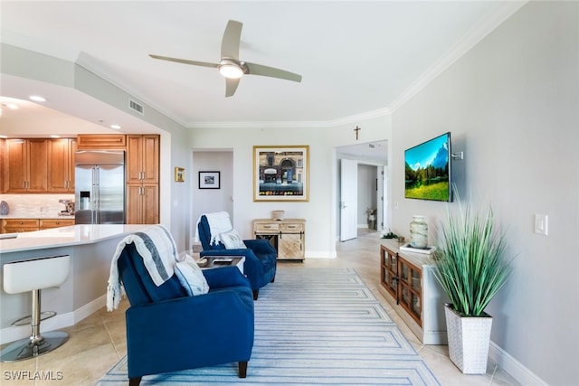 tiled living room with crown molding and ceiling fan