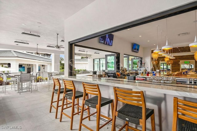 kitchen featuring ceiling fan and a breakfast bar area