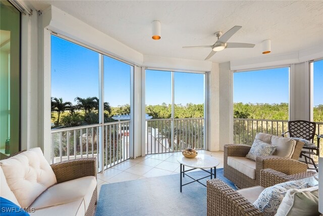 sunroom / solarium featuring ceiling fan and a wealth of natural light