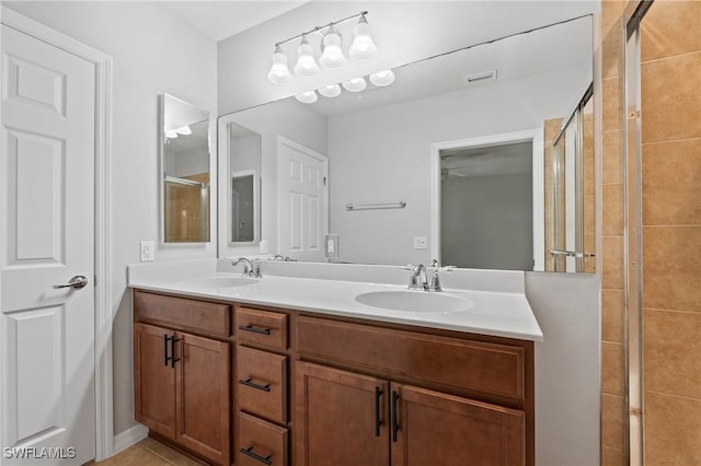 bathroom featuring tile patterned floors, vanity, and an enclosed shower