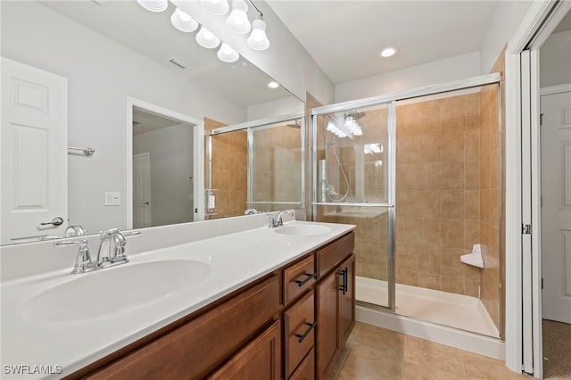 bathroom featuring vanity, tile patterned floors, and walk in shower