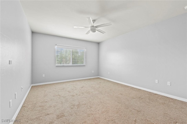 spare room featuring ceiling fan and carpet flooring