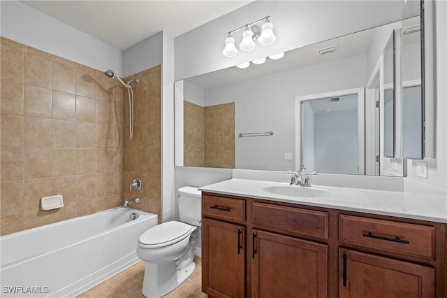 full bathroom featuring tiled shower / bath combo, vanity, tile patterned floors, and toilet