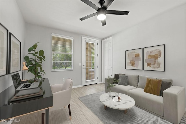 living room featuring ceiling fan and light wood-type flooring