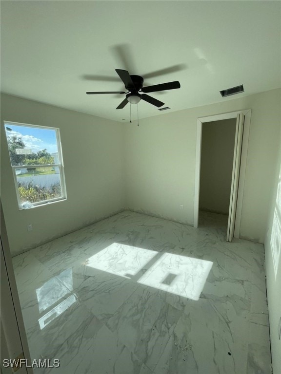 spare room with ceiling fan