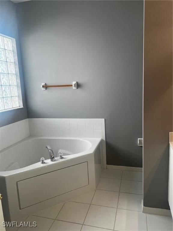 bathroom featuring tile patterned flooring, vanity, and a bathtub