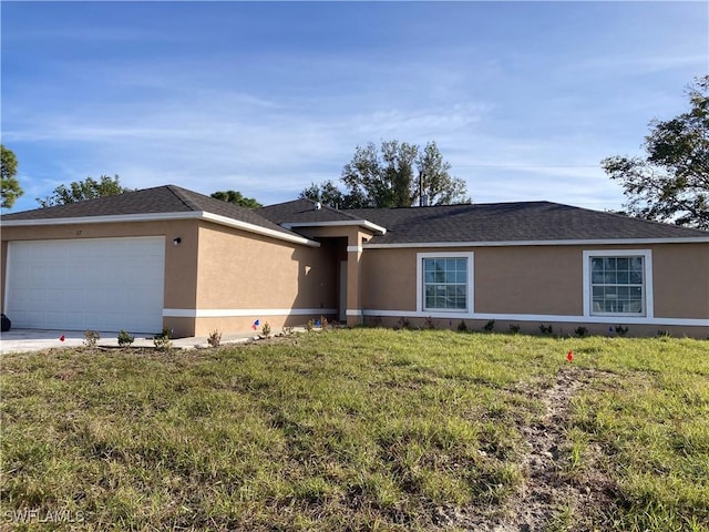 single story home with a garage and a front lawn