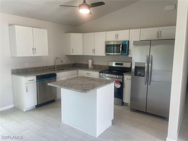 kitchen featuring white cabinets, sink, stainless steel appliances, and vaulted ceiling