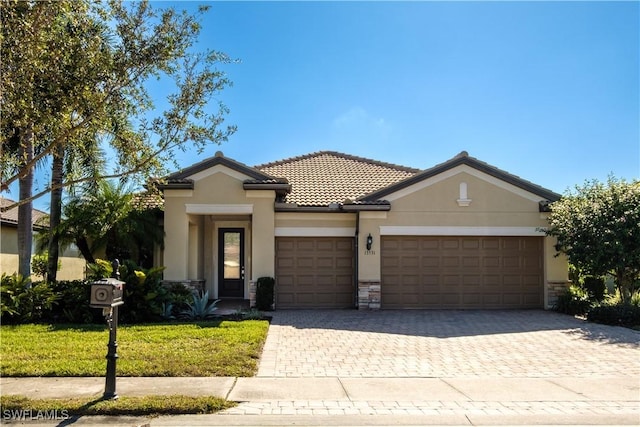 13531 Villa Di Preserve Ln, Estero, FL 33928 - view of front facade featuring a garage and a front lawn