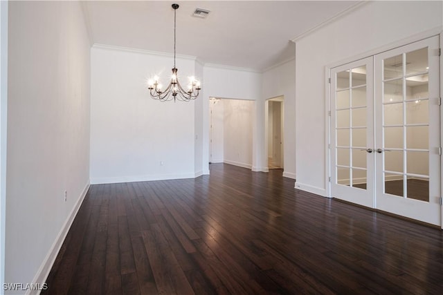 spare room featuring french doors, a chandelier, dark hardwood / wood-style floors, and ornamental molding