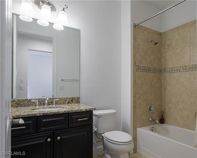 full bathroom with tiled shower / bath combo, toilet, and vanity