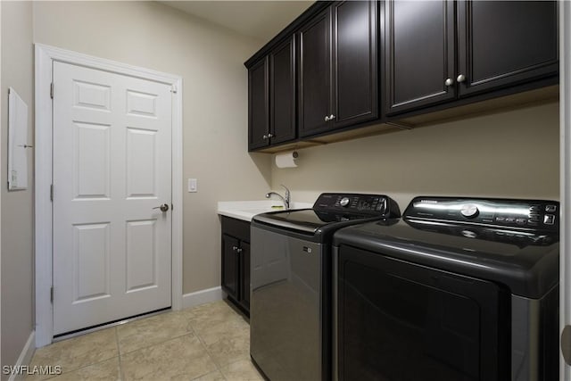 laundry room with cabinets, sink, washer and clothes dryer, and light tile patterned flooring