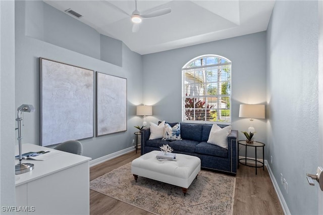 living room with ceiling fan and wood-type flooring