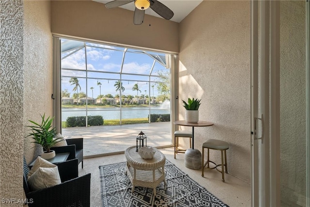 interior space with ceiling fan and a water view