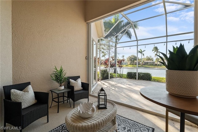 view of patio featuring a lanai and a water view