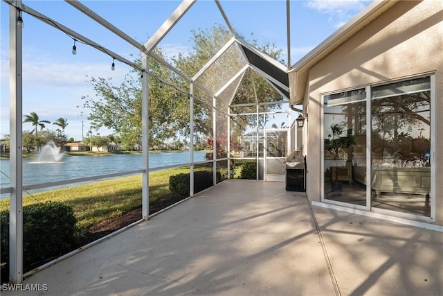 unfurnished sunroom featuring a water view and a wealth of natural light