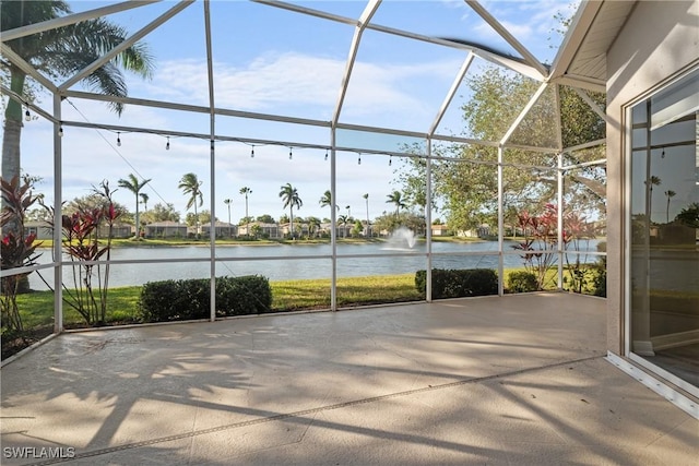 unfurnished sunroom with a water view