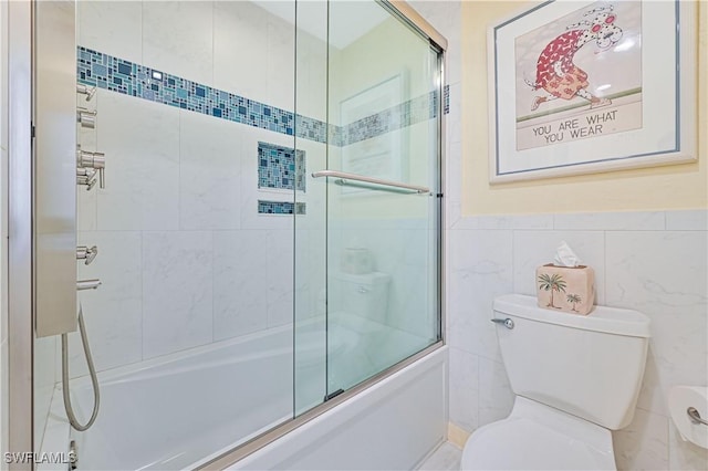 bathroom featuring toilet, tile walls, and enclosed tub / shower combo