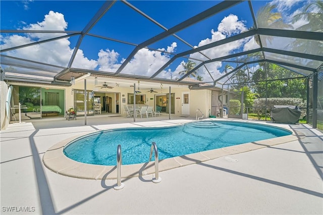 view of pool with a lanai, ceiling fan, and a patio