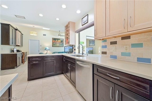 kitchen featuring pendant lighting, sink, light tile patterned floors, kitchen peninsula, and stainless steel appliances