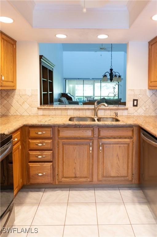 kitchen featuring tasteful backsplash, sink, light tile patterned floors, dishwasher, and range