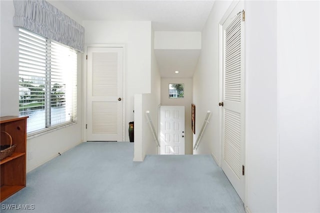 hallway with light colored carpet