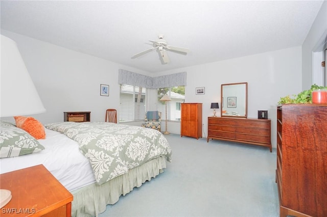 bedroom with ceiling fan and light carpet