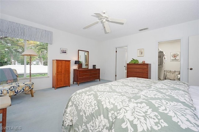 carpeted bedroom featuring ensuite bathroom and ceiling fan