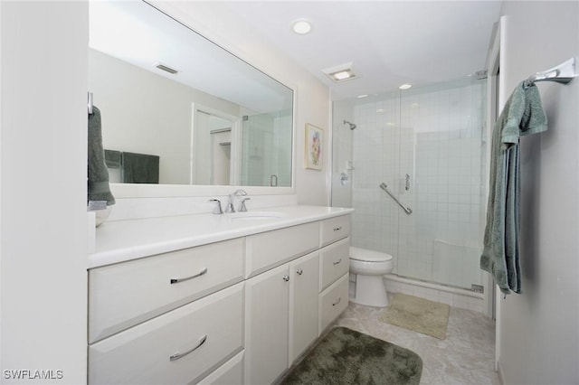 bathroom featuring tile patterned floors, vanity, toilet, and an enclosed shower