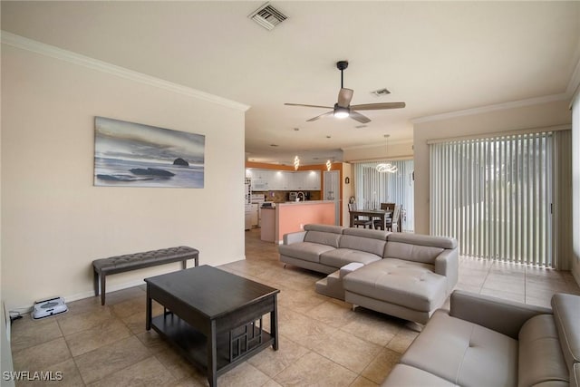 tiled living room with ceiling fan and ornamental molding