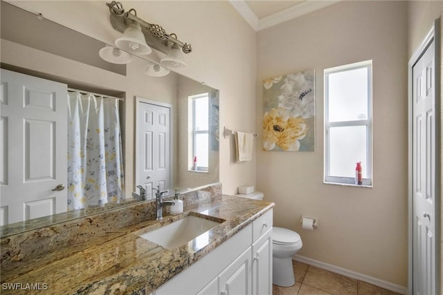 bathroom with tile patterned floors, vanity, a healthy amount of sunlight, and crown molding