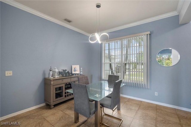 dining room featuring crown molding