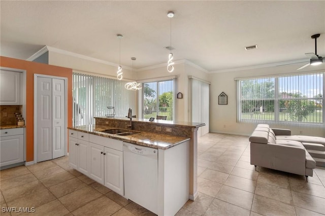 kitchen featuring dishwasher, a wealth of natural light, white cabinetry, and a kitchen island with sink